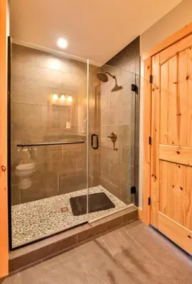 a shower with a glass door in a bathroom at Luxurious Home & Amazing Views in Windham