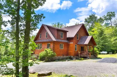 a log home with a gambrel roof at Luxurious Home & Amazing Views in Windham