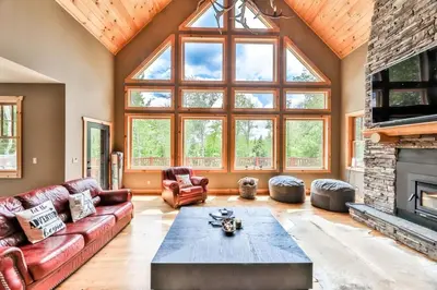 a living room with a couch and a fireplace at Luxurious Home & Amazing Views in Windham