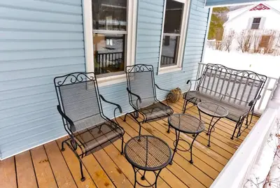 a porch with three chairs and a bench on a house at Majestic Mountain Retreat with Fire Pit Facing Mtn in Hunter
