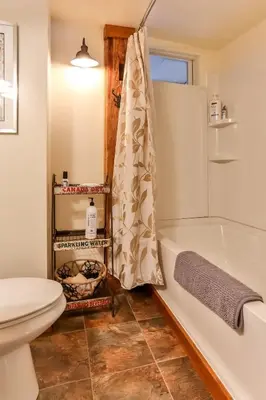 a bathroom with a white tub and a toilet at Majestic Mountain Retreat with Fire Pit Facing Mtn in Hunter
