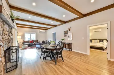 a living room with a table and chairs at Mountain Cabin with Scenic Views and Hot Tub in Windham