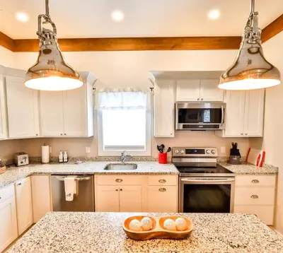 a kitchen with white cabinets and a granite counter top at Mountain Cabin with Scenic Views and Hot Tub in Windham