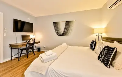 a bedroom with a large white bed and a desk at Mountain Cabin with Scenic Views and Hot Tub in Windham