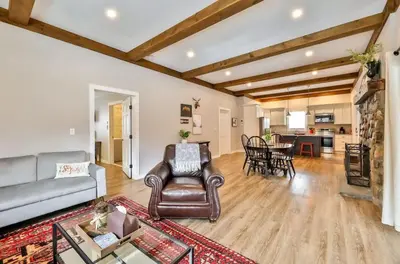a living room with a couch and a table at Mountain Cabin with Scenic Views and Hot Tub in Windham