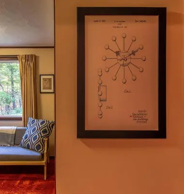 a picture hanging on a wall in a living room at Retro Retreat Charming Home with Hot Tub & Fire Pit in Hensonville