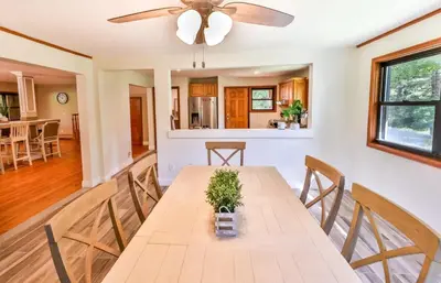a dining room and kitchen with a table and chairs at Stream-Side Atrium Home with Side Rooms & Pool Table in Hunter