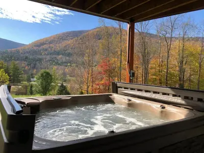 a hot tub with a view of a mountain at Stunning Home with Hot Tub Fire Pit & Amazing Views in Hunter