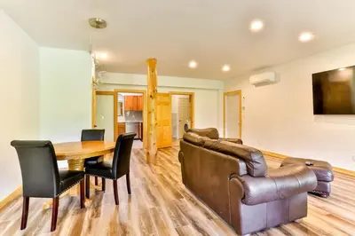 a dining room with a couch and a table and chairs at Stunning Home with Hot Tub Fire Pit & Amazing Views in Hunter