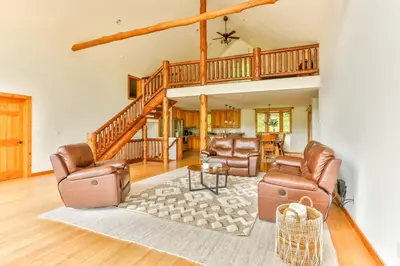 a living room with two leather chairs and a table at Stunning Home with Hot Tub Fire Pit & Amazing Views in Hunter