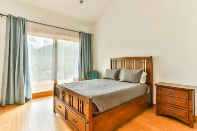 a bedroom with a bed and a dresser and a window at Stunning Home with Hot Tub Fire Pit & Amazing Views in Hunter
