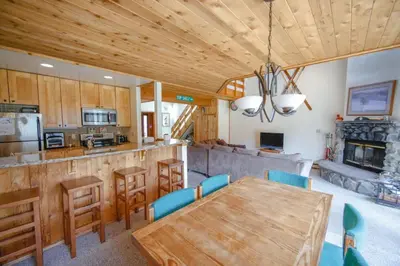 a kitchen with a wooden table and a dining room at Windham Mountain Village Condo in Windham