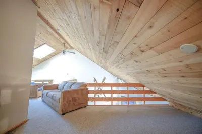 a living room with a couch and a wooden ceiling at Windham Mountain Village Condo in Windham