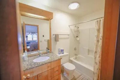 a bathroom with a sink and a toilet and a tub at Windham Mountain Village Condo in Windham