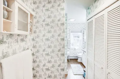 a bathroom with a toilet and a wall at Lake Views and Dock Access - Pittsfield Cottage! in Pittsfield