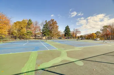 a tennis court with two tennis courts at Near Water Parks Pet-Friendly Tobyhanna Getaway! in Tobyhanna