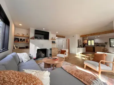 a living room with a couch and a fireplace at Luxury Woodstock Retreat Hot tub and heated pool in Woodstock