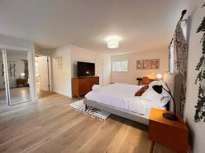 a bedroom with a bed and a television in it at Luxury Woodstock Retreat Hot tub and heated pool in Woodstock