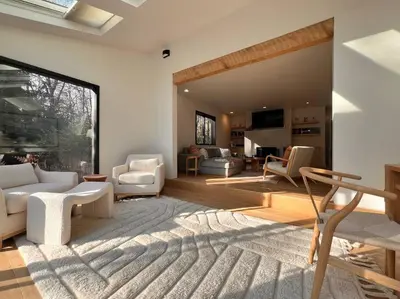 a living room with white furniture and a large window at Luxury Woodstock Retreat Hot tub and heated pool in Woodstock