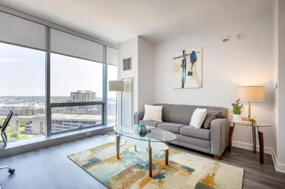a living room with a couch and a glass table at Private Luxury Apt with Gym in Stamford