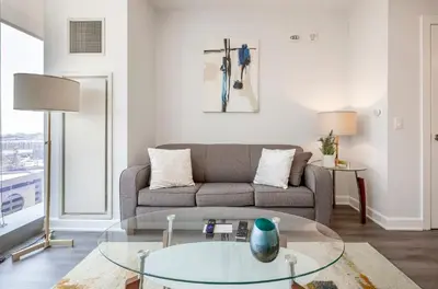 a living room with a couch and a glass table at Private Luxury Apt with Gym in Stamford