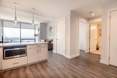 an open kitchen and living room with a large window at Private Luxury Apt with Gym in Stamford