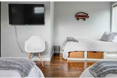 a bedroom with a bed and a tv on the wall at Luxury Woodstock Family Retreat with pool hot tub in Woodstock