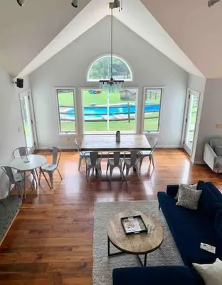 a living room with a table and chairs at Luxury Woodstock Family Retreat with pool hot tub in Woodstock