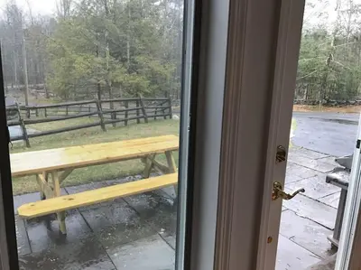 a wooden bench sitting outside of a door at Luxury Woodstock Family Retreat with pool hot tub in Woodstock