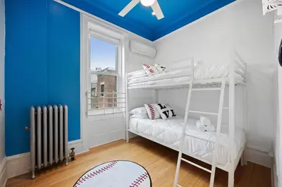 a room with a white bunk bed and a blue ceiling at Vintage Luxe NY - Designer Lofts & Apartments NYC in New York