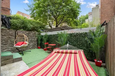 a large red and white striped table in a garden at Vintage Luxe NY - Designer Lofts & Apartments NYC in New York