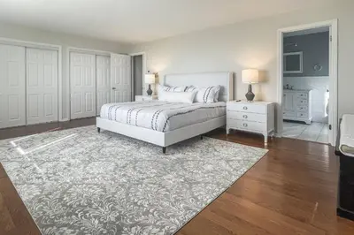 a bedroom with a white bed and a rug at Akasa in Stratford