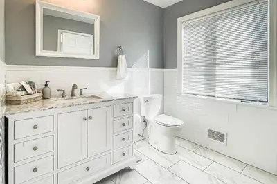 a bathroom with a sink and a toilet and a window at Akasa in Stratford