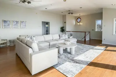 a living room with a white couch and a table at Akasa in Stratford