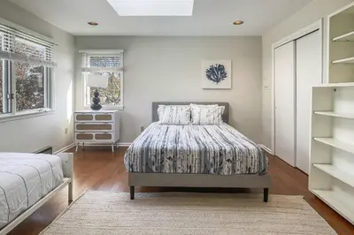 a bedroom with a bed and a book shelf at Akasa in Stratford
