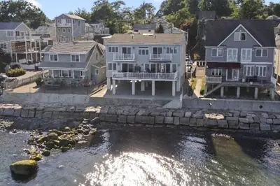 a group of houses next to a body of water at Sunrise Waterfront Retreat in Milford