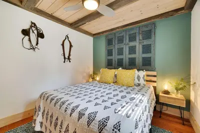 a bedroom with a bed and a ceiling fan at Poconos Cabin Year Round Bliss in Greentown