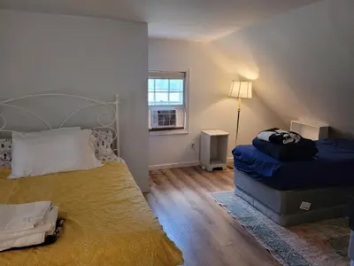 a bedroom with a large bed and a window at East Granby with AC and WiFi 3 minute to Bradley in East Granby