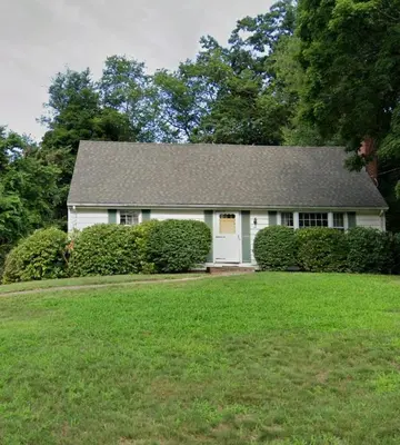 a white house with a gray roof and a yard at East Granby with AC and WiFi 3 minute to Bradley in East Granby