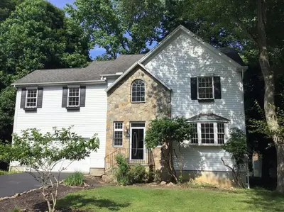 a gray and white house with a tree at Enjoy all Westport has to offer! in Westport