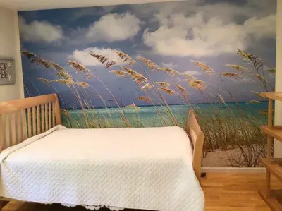 a bedroom with a mural of a beach and grass at Enjoy all Westport has to offer! in Westport
