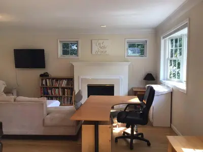a living room with a table and a couch at Enjoy all Westport has to offer! in Westport