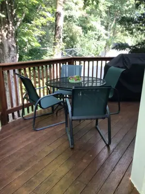 a patio with a table and chairs on a deck at Enjoy all Westport has to offer! in Westport