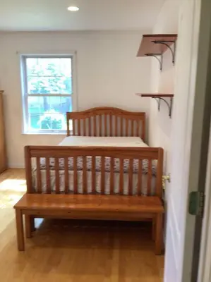 a wooden bench in a room with a bed at Enjoy all Westport has to offer! in Westport