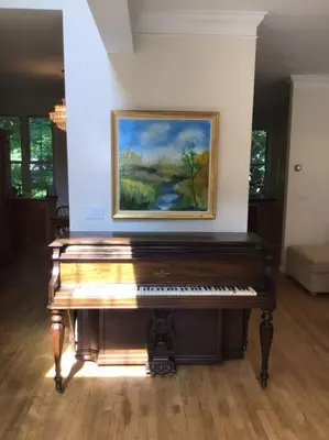 a piano in a room with a painting on the wall at Enjoy all Westport has to offer! in Westport