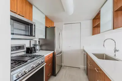 a kitchen with a stove and a sink at Blueground Jersey City 1bd apartment NYC-1603 in New York