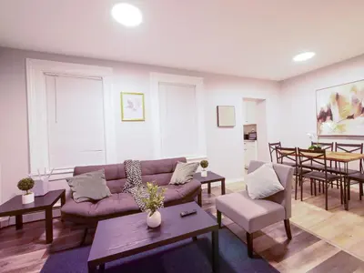 a living room with a couch and a table at Modern comfort-2BR haven mins to NYC in Jersey City