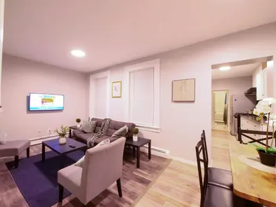 a living room with a couch and a table at Modern comfort-2BR haven mins to NYC in Jersey City