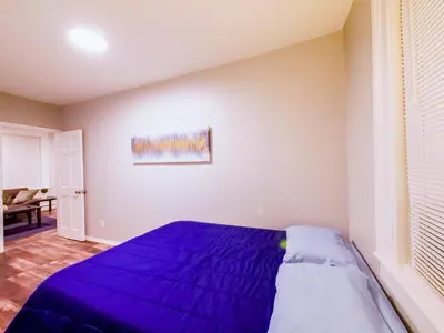 a bedroom with a purple bed in a room at Modern comfort-2BR haven mins to NYC in Jersey City