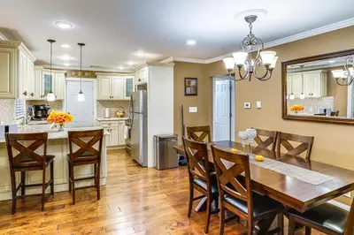 a kitchen and dining room with a table and chairs at Private Hot Tub on 10 Acres Cozy Catskill Getaway in Catskill